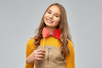 Image showing happy teenage girl with red bowtie party accessory