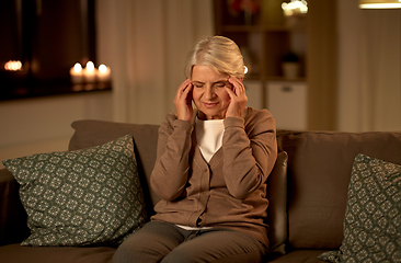 Image showing unhappy senior woman suffering from headache