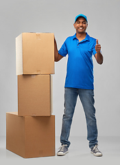 Image showing happy indian delivery man with parcel boxes