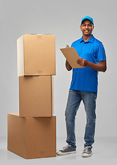 Image showing indian delivery man with boxes and clipboard