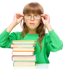 Image showing Little girl is reading a book