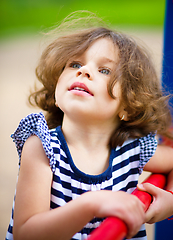 Image showing Cute little girl is playing in playground