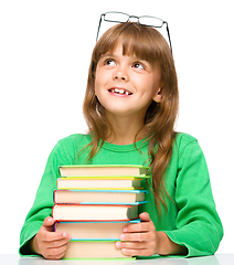 Image showing Little girl is reading a book