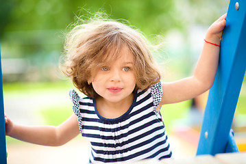 Image showing Cute little girl is playing in playground
