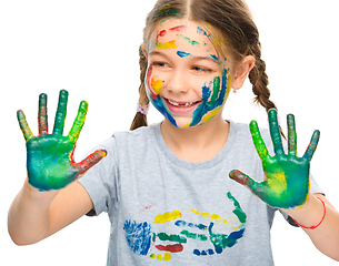 Image showing Portrait of a cute girl playing with paints