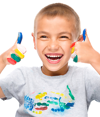 Image showing Portrait of a cute boy playing with paints