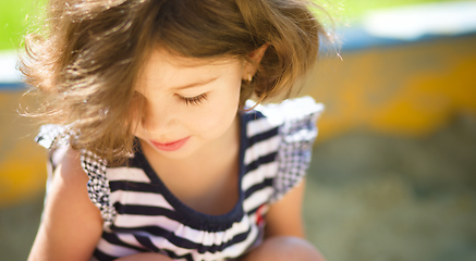 Image showing Cute little girl is playing in playground