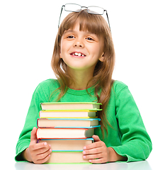 Image showing Little girl is reading a book