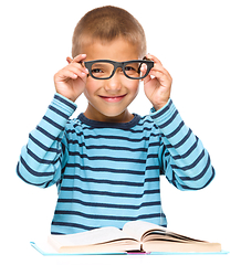 Image showing Little boy is reading a book