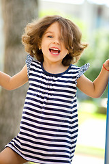 Image showing Cute little girl is playing in playground