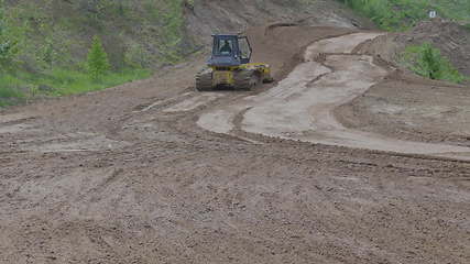 Image showing Bulldozer on tracks at the mountain road construction. UltraHD stock footage