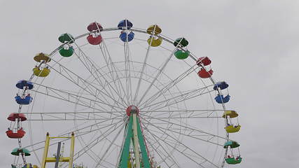 Image showing Underside view of a ferris wheel over blue sky.