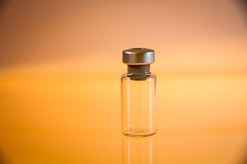 Image showing Vaccine bottle on orange background