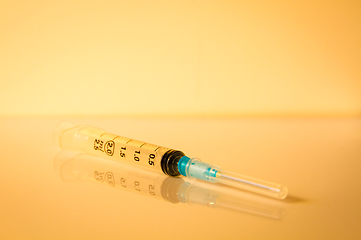 Image showing Syringe on orange background