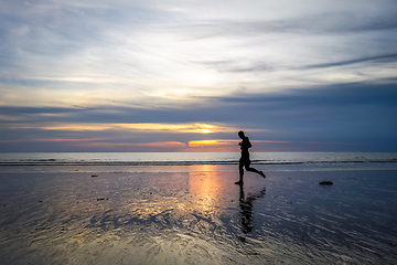 Image showing Jogger on Nai Yang Beach at sunset, Phuket, Thailand