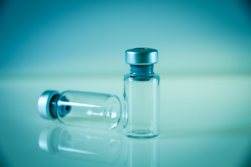 Image showing two vaccine bottles on blue background