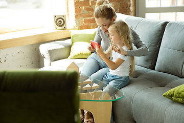 Image showing Teacher and little girl, or mom and daughter. Homeschooling concept