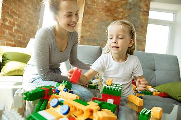 Image showing Teacher and little girl, or mom and daughter. Homeschooling concept