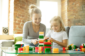 Image showing Teacher and little girl, or mom and daughter. Homeschooling concept