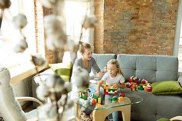 Image showing Teacher and little girl, or mom and daughter. Homeschooling concept