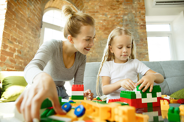 Image showing Teacher and little girl, or mom and daughter. Homeschooling concept