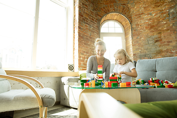 Image showing Teacher and little girl, or mom and daughter. Homeschooling concept