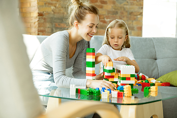 Image showing Teacher and little girl, or mom and daughter. Homeschooling concept