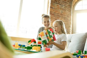 Image showing Teacher and little girl, or mom and daughter. Homeschooling concept