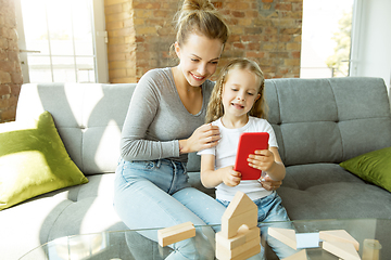 Image showing Teacher and little girl, or mom and daughter. Homeschooling concept