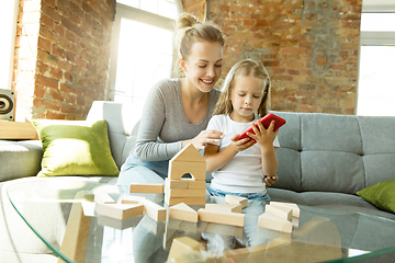 Image showing Teacher and little girl, or mom and daughter. Homeschooling concept