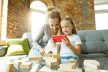 Image showing Teacher and little girl, or mom and daughter. Homeschooling concept