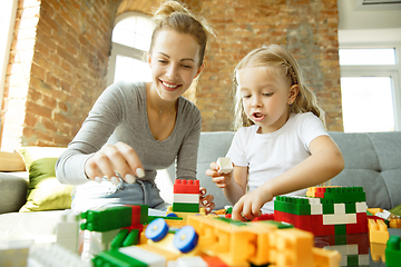 Image showing Teacher and little girl, or mom and daughter. Homeschooling concept