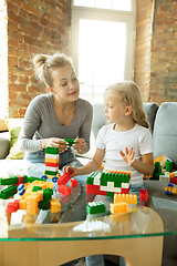 Image showing Teacher and little girl, or mom and daughter. Homeschooling concept