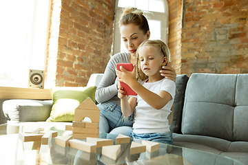 Image showing Teacher and little girl, or mom and daughter. Homeschooling concept