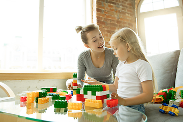 Image showing Teacher and little girl, or mom and daughter. Homeschooling concept