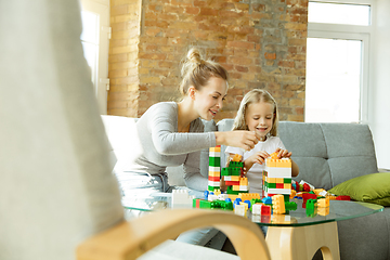 Image showing Teacher and little girl, or mom and daughter. Homeschooling concept