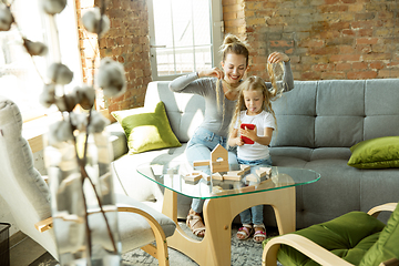 Image showing Teacher and little girl, or mom and daughter. Homeschooling concept