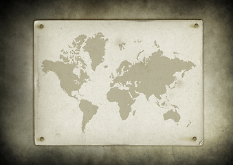 Image showing Vintage world map parchment nailed to a wall