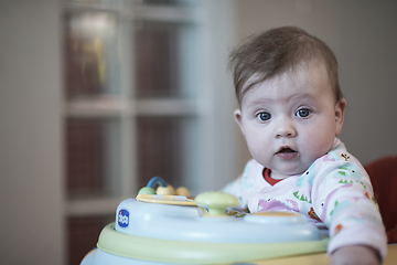 Image showing baby learning to walk in walker