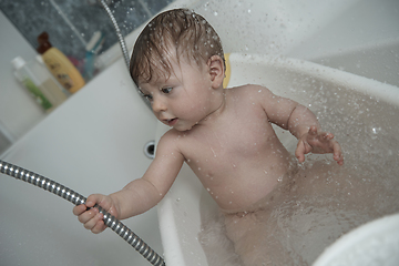 Image showing cute little baby girl taking a bath