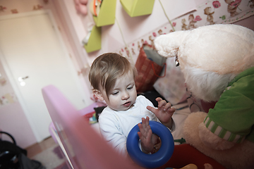 Image showing cute little one year old baby and making first steps