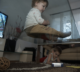 Image showing Little child playing with sister at home