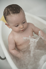 Image showing cute little baby girl taking a bath