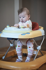 Image showing baby learning to walk in walker