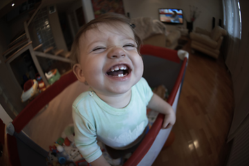 Image showing cute little baby playing in mobile bed