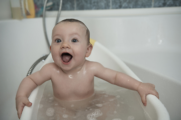 Image showing cute little baby girl taking a bath