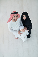 Image showing Top view of young arabian muslim family wearing traditional clothes