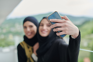 Image showing Portrait of young muslim women taking selfie on the balcony