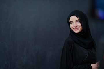 Image showing Modern young muslim woman in black abaya