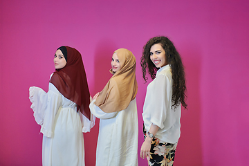 Image showing Young muslim women posing on pink background